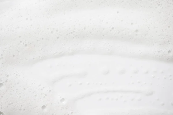 Abstraktní pozadí bílé textury mýdlovou pěnu. Šampón pěna s — Stock fotografie