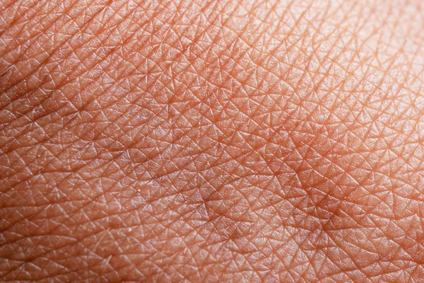 Textuur van de huid. Donkere huid van vrouw hand macro. Menselijke huidtextuur achtergrond — Stockfoto