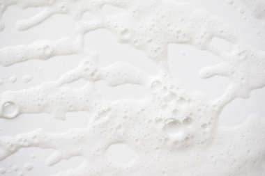 Arka plan beyaz sabunlu köpük doku. Şampuan köpük ile 