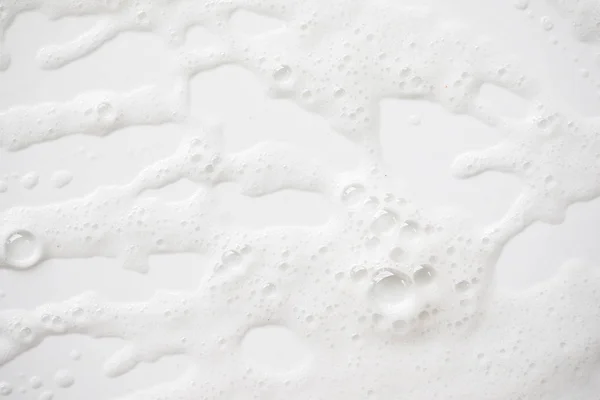 Fondo abstracto textura de espuma jabonosa blanca. espuma de champú con —  Fotos de Stock