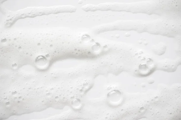 Arka plan beyaz sabunlu köpük doku. Şampuan köpük ile — Stok fotoğraf