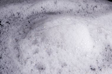 Soyut arka plan beyaz sabunlu köpük dokusu. Köpüklü şampuan köpüğü.