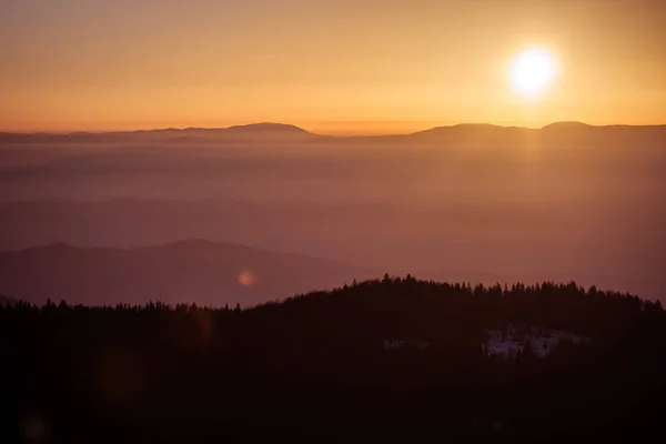 Sunset in Foggy Mountains