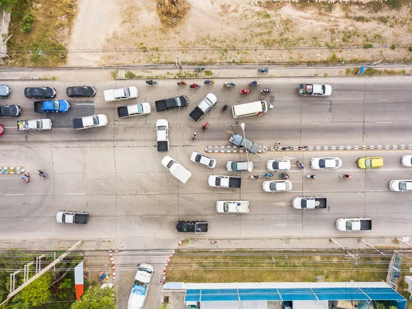 Aerial view from camera drone of street with traffic jam caused by accident around a U-turn