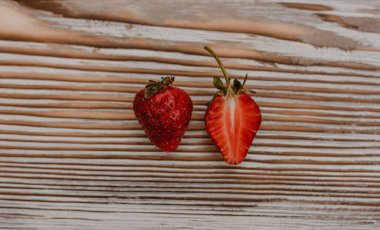 Masanın üzerine taze sulu kırmızı çilekler ve kaliteli kalaslar serpiştirdim. Nane yaprağı. Damlalar ve dökülen sütler. Sebze kesme tahtası. Yüksek kalite fotoğraf