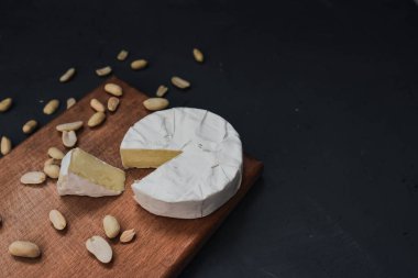 Tahtada küflü ve fındıklı peynirli camembert peyniri.