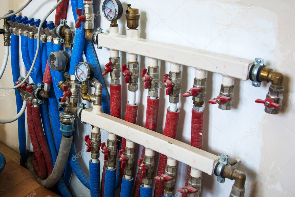 Copper valves, stainless ball valves, detector of water and plastic pipes of central heating system and water pipes in apartment during renovation, remodeling and construction