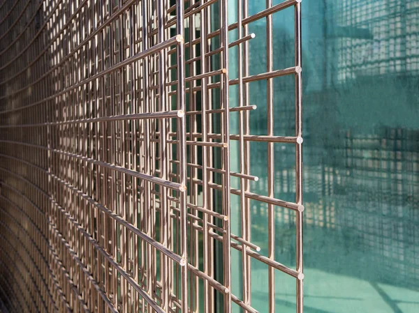 Close up of welded wire mesh with glass background, copy space