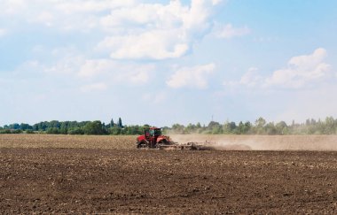 Bir çiftçi traktör arazi öncesi tohumlama faaliyetleri kapsamında fidelik Kültüvatör ile hazırlanıyor. Tarım tarım arazileri kabilelerini başlangıcı.