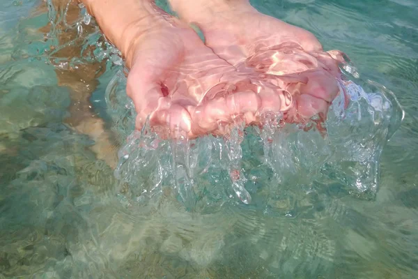 Woman handful of clear blue water close-up — Stock Photo, Image