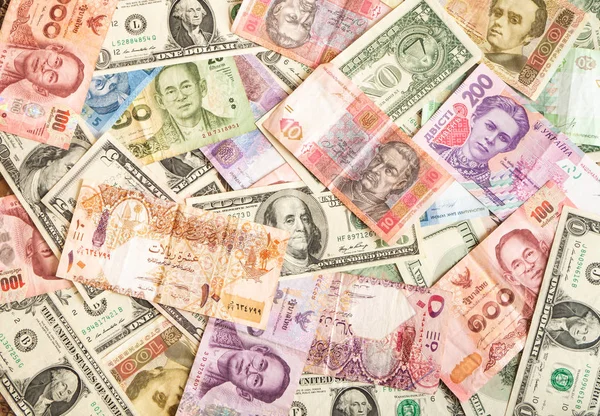 Background made of dollar, Thai baht, Qatari riyal, hryvnia banknotes — Stock Photo, Image