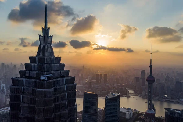 Sunset of Shanghai Skyline And Skyscrapers. Silhouette Of Oriental Pearl Tower And Huangpu River On Background.