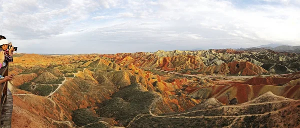 Panorama View of Rainbow Mountains Geological Park. Stripy Zhangye Danxia Landform Geological Park in Gansu Province, China. Road in a Valley on a Sunny Day.