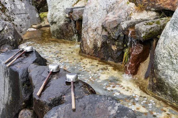 Ladles And Water Pond Full Of Coins.