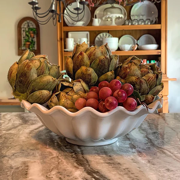 Bowl Grapes Artichokes Bowl Sits Granite Countertop Country Kitchen View — Stock Photo, Image