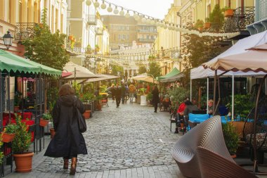TBILISI, GEORGIA - NOV 01 2018: People walking on reconstructed street David Agmashenebeli with lot of new restaurants and cafes clipart