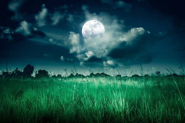 Night sky with clouds and full moon behind partial cloudy above