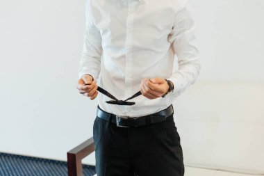 Otel eğitim kampındaki damadın portreleri. Siyah takım elbise, smokin ve beyaz gömlek giymiş bir iş adamı gibi giyinmiş.