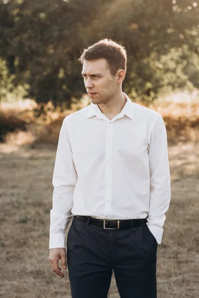 Güzel bir çift, kırmızı elbiseli bir kız ve beyaz gömlekli bir adam, parkta yürüyorlar.