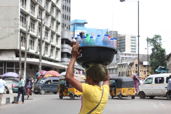 10th September 2019 Lagos Nigeria,  Editorial image of a lady selling cool bottle water in Broad street ,Lagos Nigeria. Selling ice cool bottle water is a common site in Lagos business district.