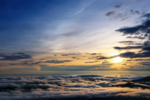 Beautiful nature landscape the sun is above the sea fog that covers the mountains and bright sky during sunrise in the winter at viewpoint of Phu Ruea National Park, Loei province, Thailand.