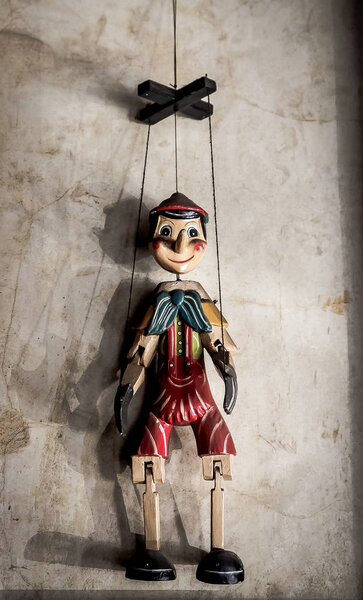 Selective Focus Abstract image of a Wooden String Puppet Boy hanging on a wall