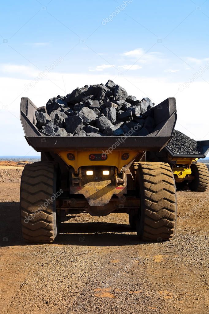 Manganese Mining and processing, large ore rocks being transported on Dump rock trucks