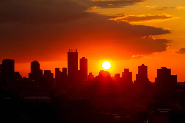 Urban City landscape view of Silhouetted high rise buildings at Sunset in Johannesburg South Africa