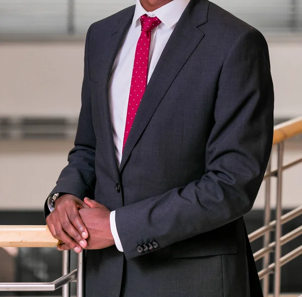 Close-up cropped African hands and arms of businessman in an office