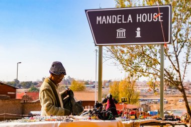 Johannesburg, South Africa, July 12, 2009, Old Lady selling African Curios on sale Outside Nelson Mandela's house in Vilakazi Street Soweto clipart