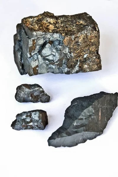 Close up of a selection of small Manganese Ore rocks on a white background