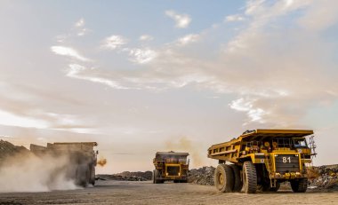 Dump Trucks transporting Platinum ore for processing clipart