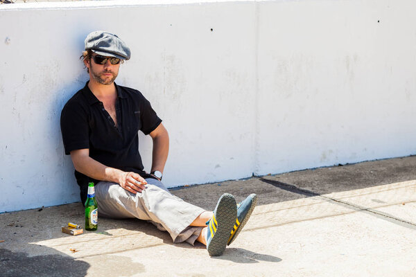 Jay Kay of Jamiroquai relaxing with a Cigarette next to a race t