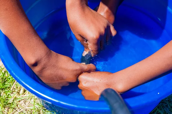 African Children fixing a puncture on a bike — Stock Photo, Image