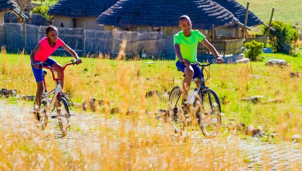 African Children riding a bike in rural a village — Stock Photo, Image