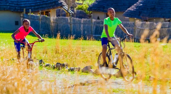 African Children riding a bike in rural a village — Stock Photo, Image