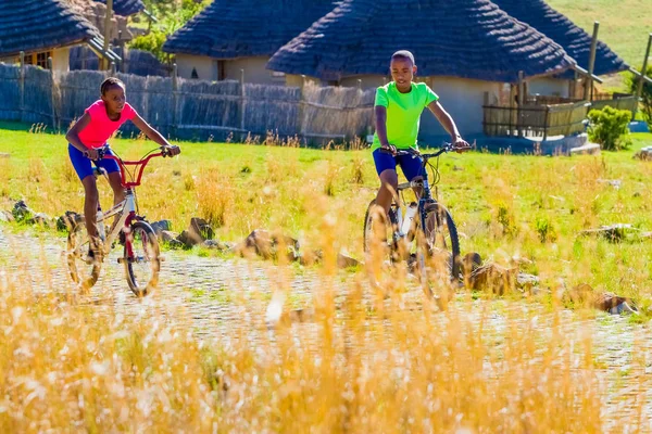 African Children riding a bike in rural a village — Stock Photo, Image