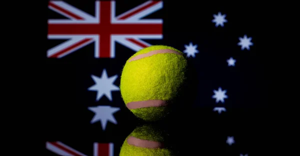 Yellow Tennis Ball Black Mirror Australian Flag Background Out Focus — Stock Photo, Image