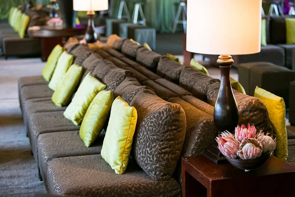 Comfy couches and flower arrangement at corporate party event or gala dinner