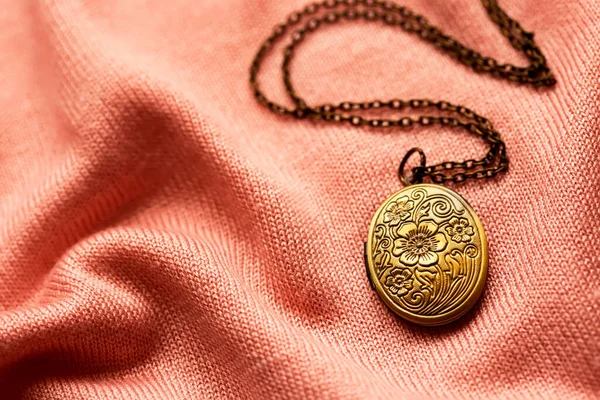 Old Bronze Antique Locket Soft Pink Fabric Background Vintage Jewelry — Stock Photo, Image