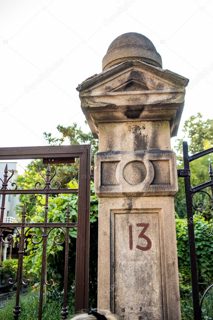 Unlucky number 13, thirteen painted on stone and metal vintage road door column in Sofia, Bulgaria