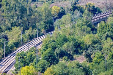Bir orman, Karlukovo, güneşli bir sonbahar günü Kuzey Bulgaristan'da tren istasyonunun yakınında yüksek açılı görünüş yukarıdan geçiş çapraz çift demiryolu parça