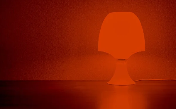 Gece lambası masanın üzerinde parlıyor..