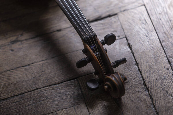 A part of a violin or a viola on a wood background