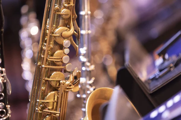 Multiple woodwind instruments on stage before a concert