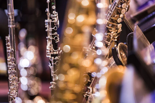 Multiple woodwind instruments on stage before a concert