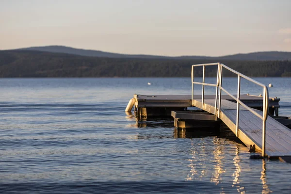 A dock on Lake Almanor, California during sunset