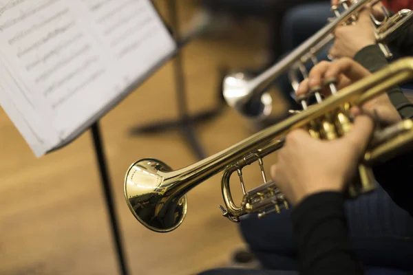 People playing the trumpet in rehearsal