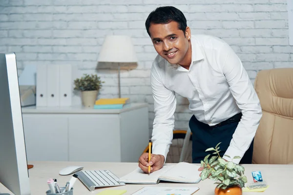 Handsome Indian Businessman Smiling Camera While Making Notes Personal Organizer — Stock Photo, Image