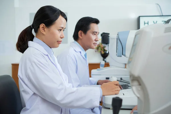 Médicos Asiáticos Que Utilizan Tecnología Moderna Mientras Trabajan Gabinete Oftalmología —  Fotos de Stock